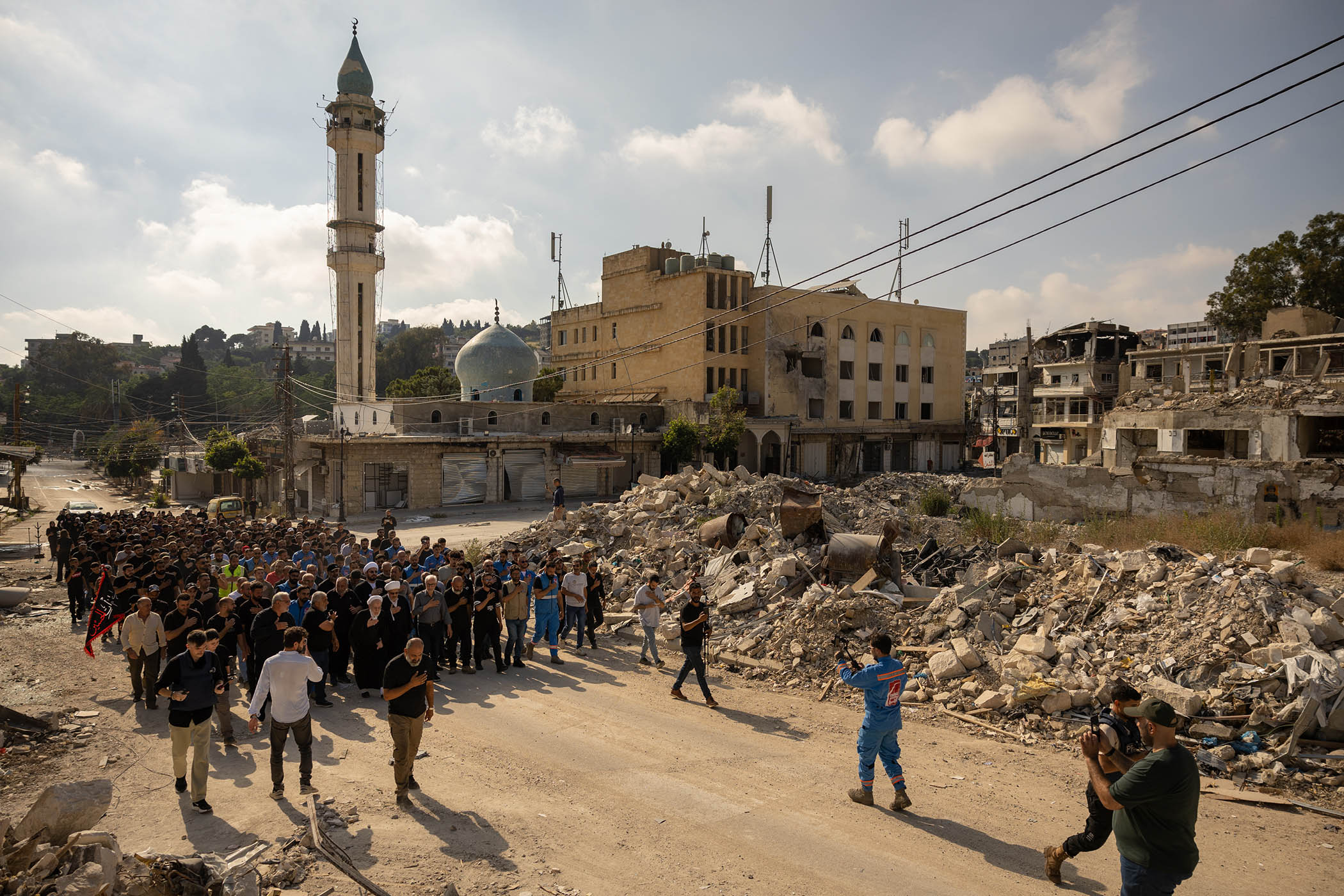 Members of Lebanon’s Shia community beat their chests and chant dirges as they follow a procession through the rubble of Nabatieh during Ashura commemorations.