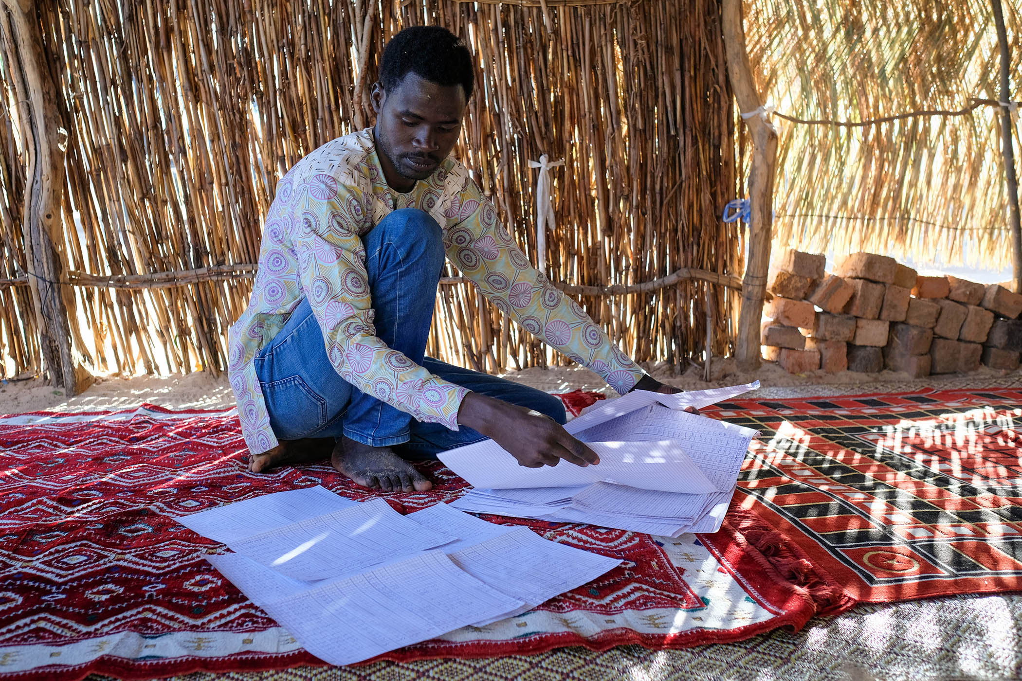 Jamal Abdulla of Jazoor and his colleagues have compiled handwritten lists with the names of people killed in El Geinina and Ardamatta for future generations.