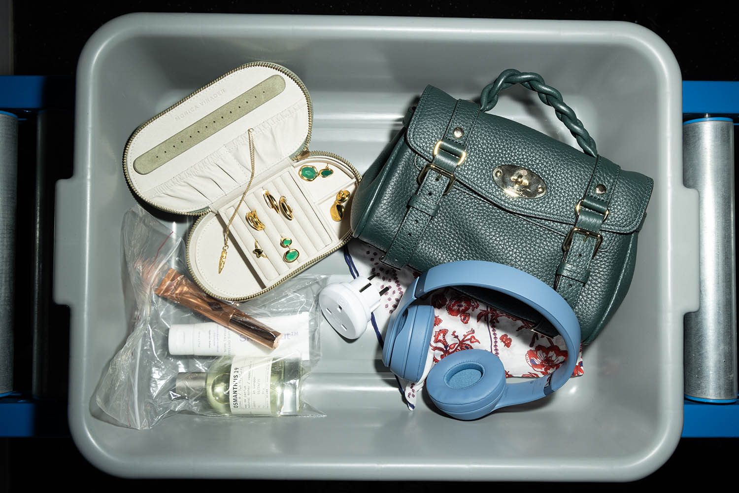 Mini Alexa bag by Mulberry; headphones by Beats by Dre; scarf by Gucci; jewellery box, rings and earrings by Monica Vinader; necklace by Alighieri; Osmanthus 19 fragrance by Le Labo; highlighter by Charlotte Tilbury; moisturiser by Skinstitut
