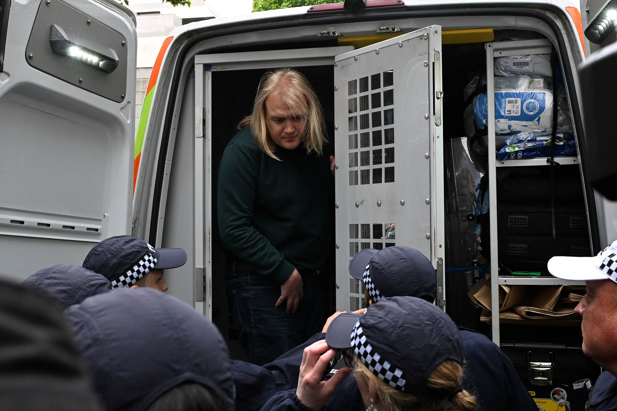 Police officers put an arrested protester in a van during a Pro-Palestine march in London