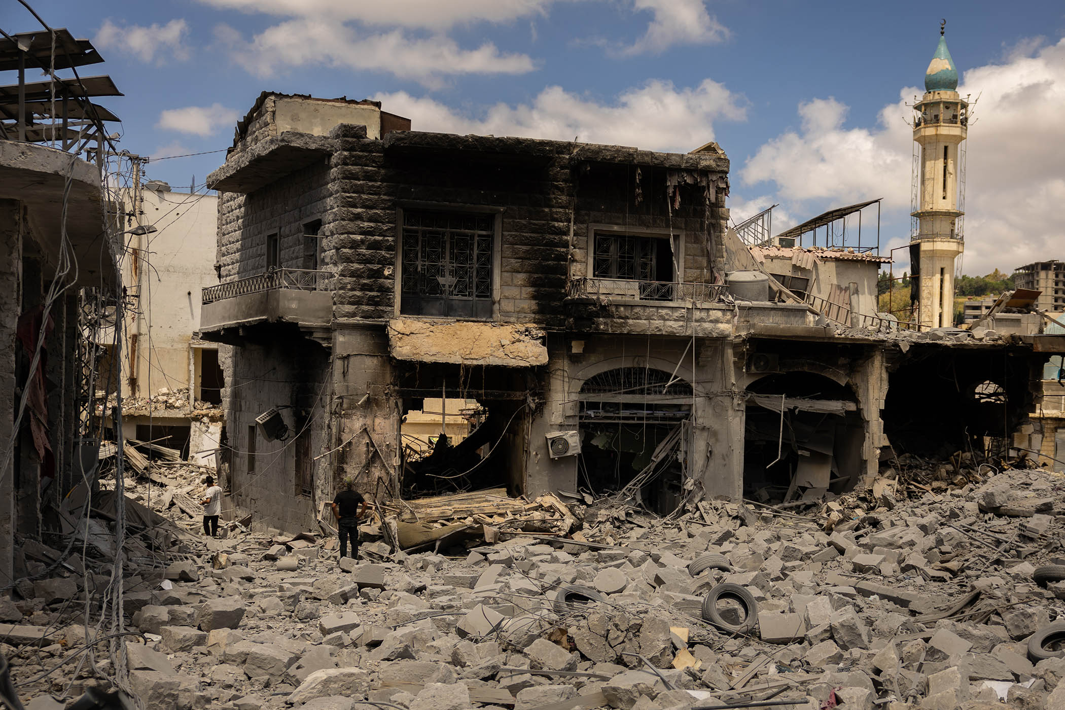 Residents of Nabatieh walk through the rubble of the 400-year-old Ottoman-era souk.