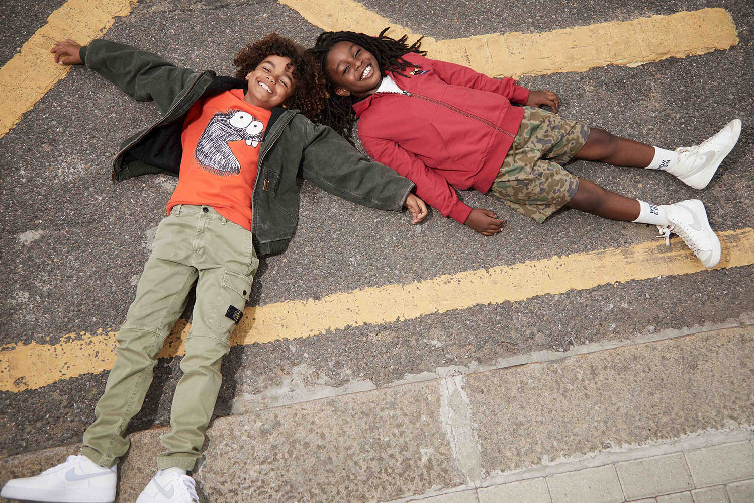 Raphael (left) Jacket, Carhartt from Depop. Sweatshirt, Community Clothing. Trousers, Stone Island from Depop. Pre-loved trainers, Nike Dunk from Vinted. Amar (right) Hoodie, Fendi from Depop. T-shirt, Community Clothing. Camo shorts, NEXT from Vinted. Pre-loved high-top trainers, Nike from Depop