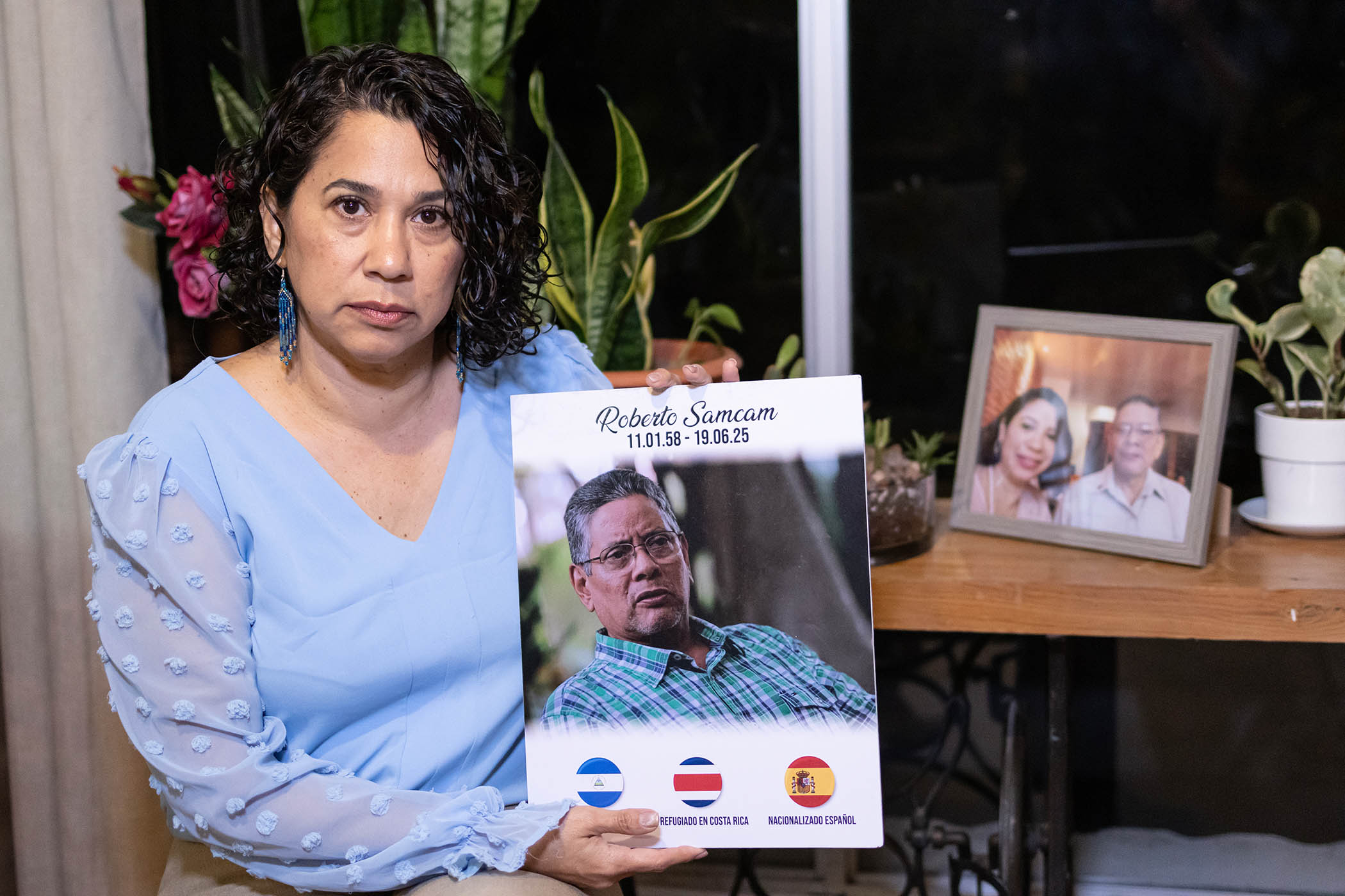 Claudia Vargas holds a photograph of her murdered husband Roberto Sancam