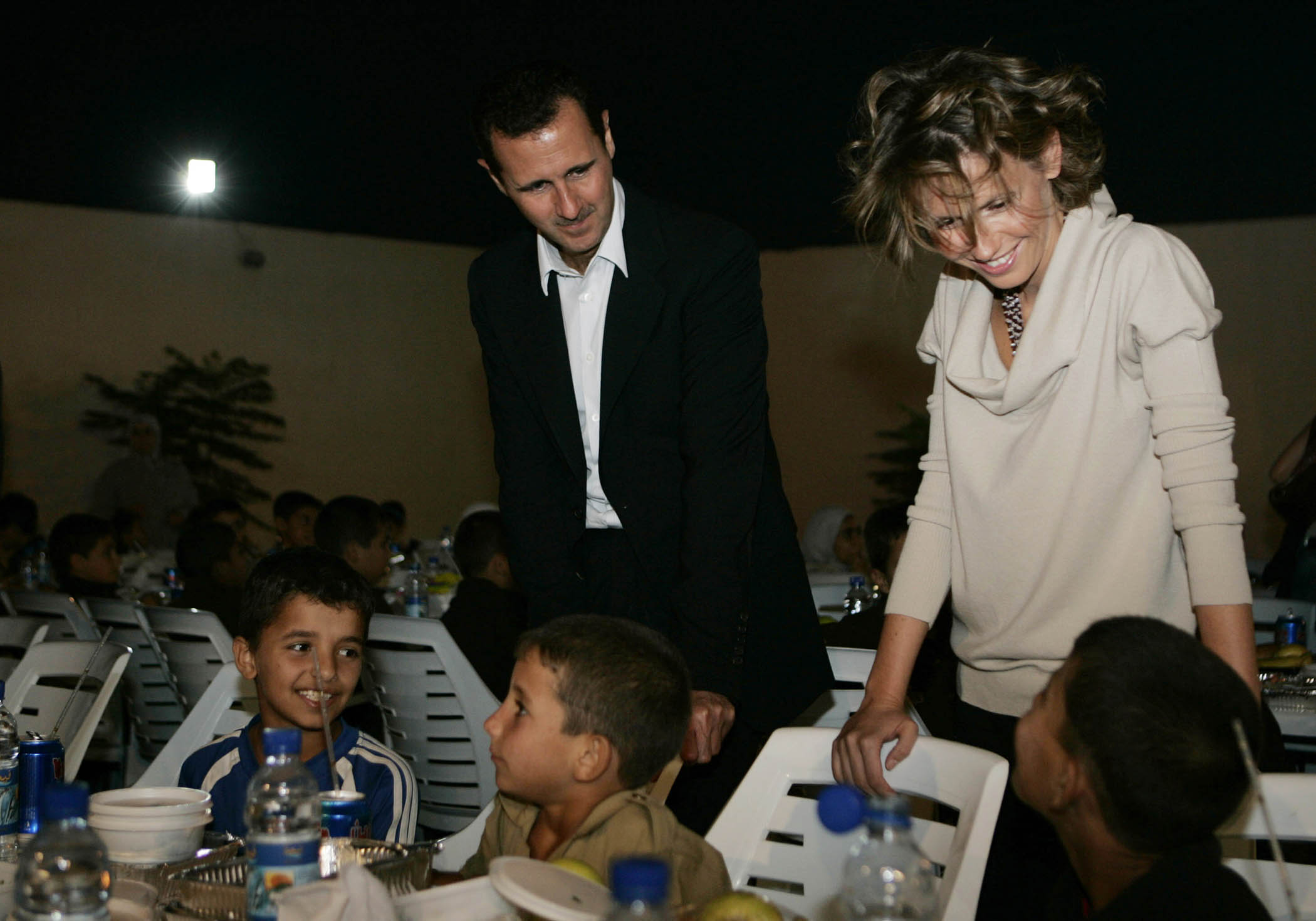 Assad and Asma meet orphans in a town south of Damascus in 2008.