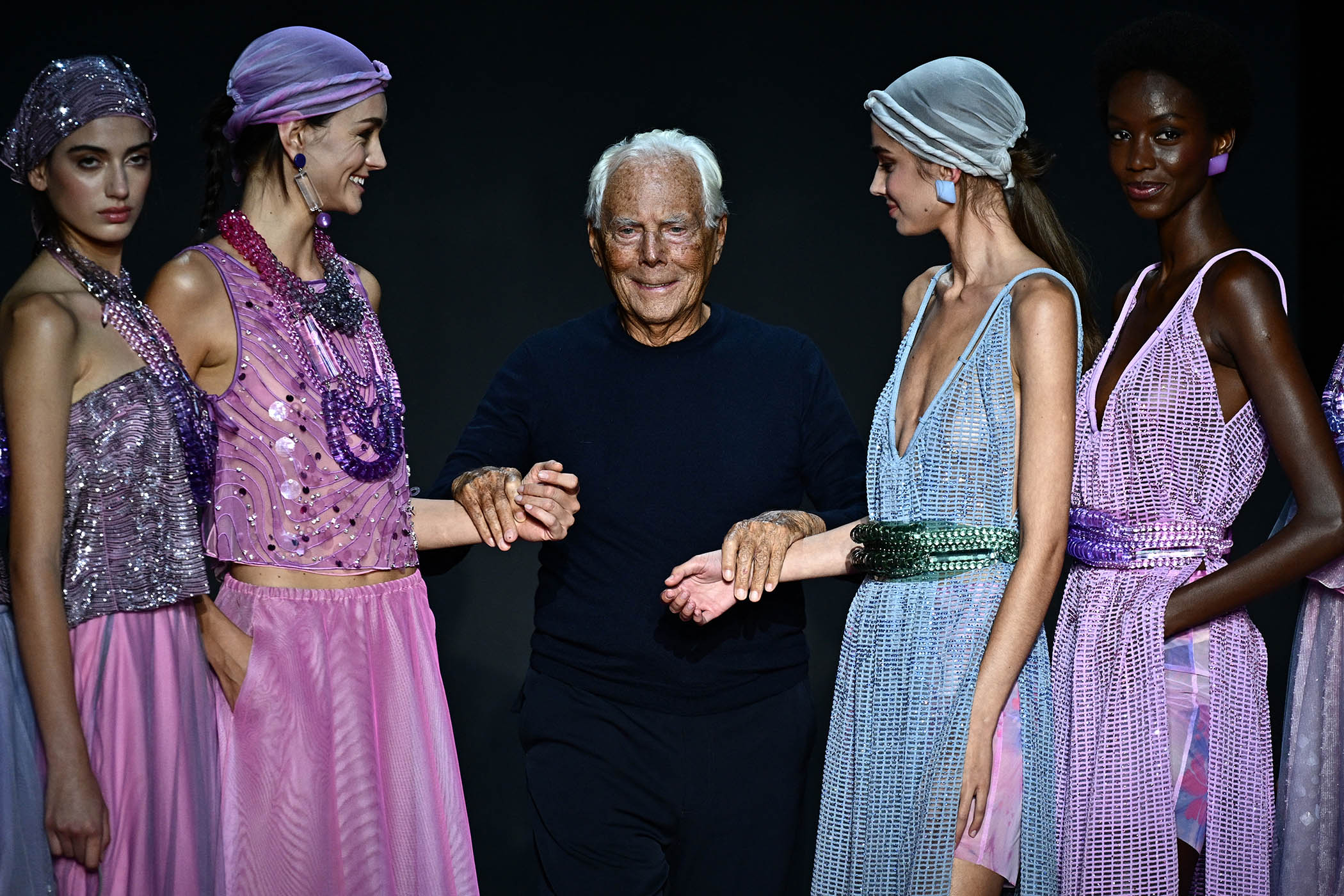 Purple reign: Armani poses with models on the runway at the end of the Emporio Armani fashion show during the Milan Fashion Week Womenswear Spring/Summer 2024 on 21 September 2023
