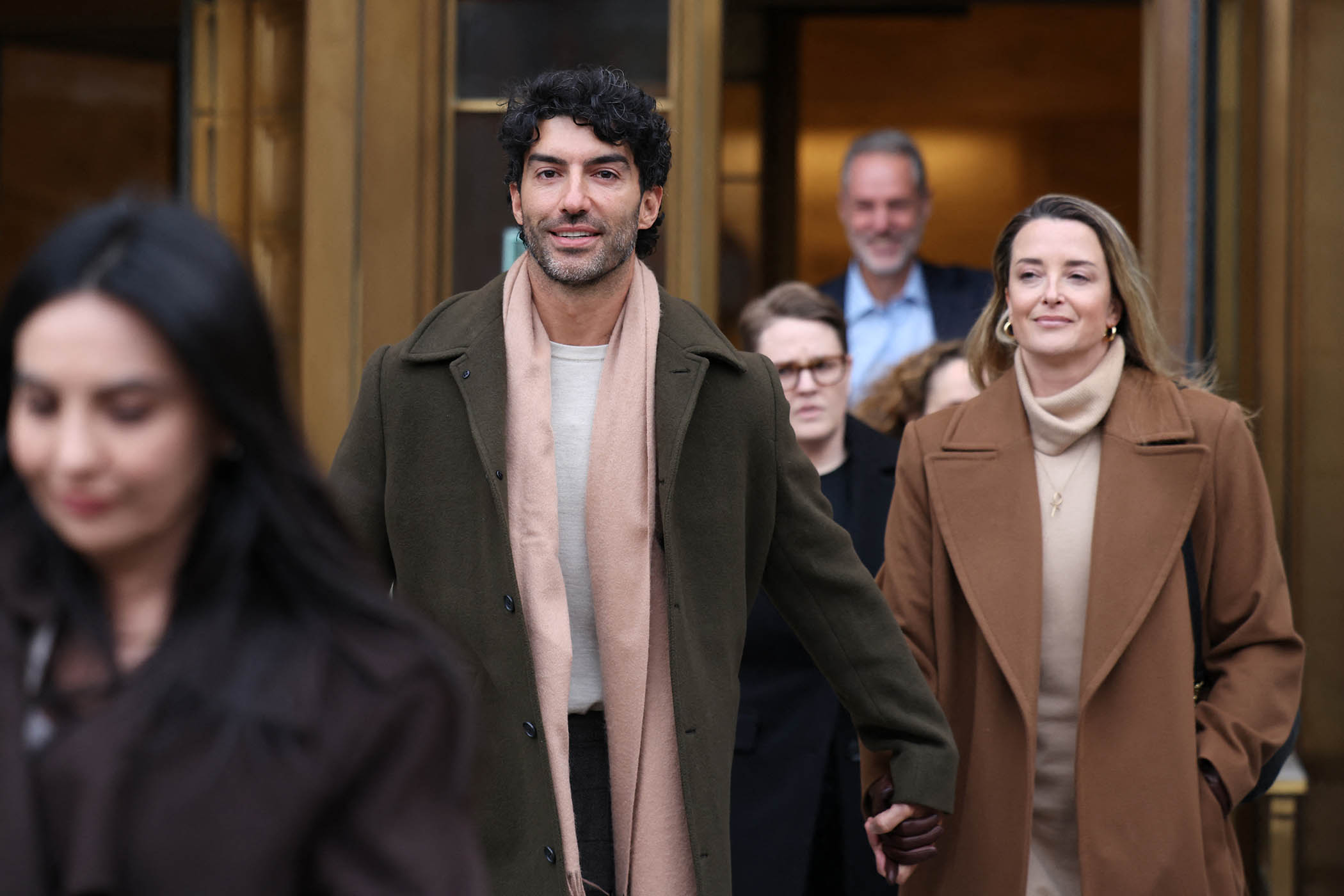 Justin Baldoni leaves federal court holding hands with his wife, Emily Baldoni
