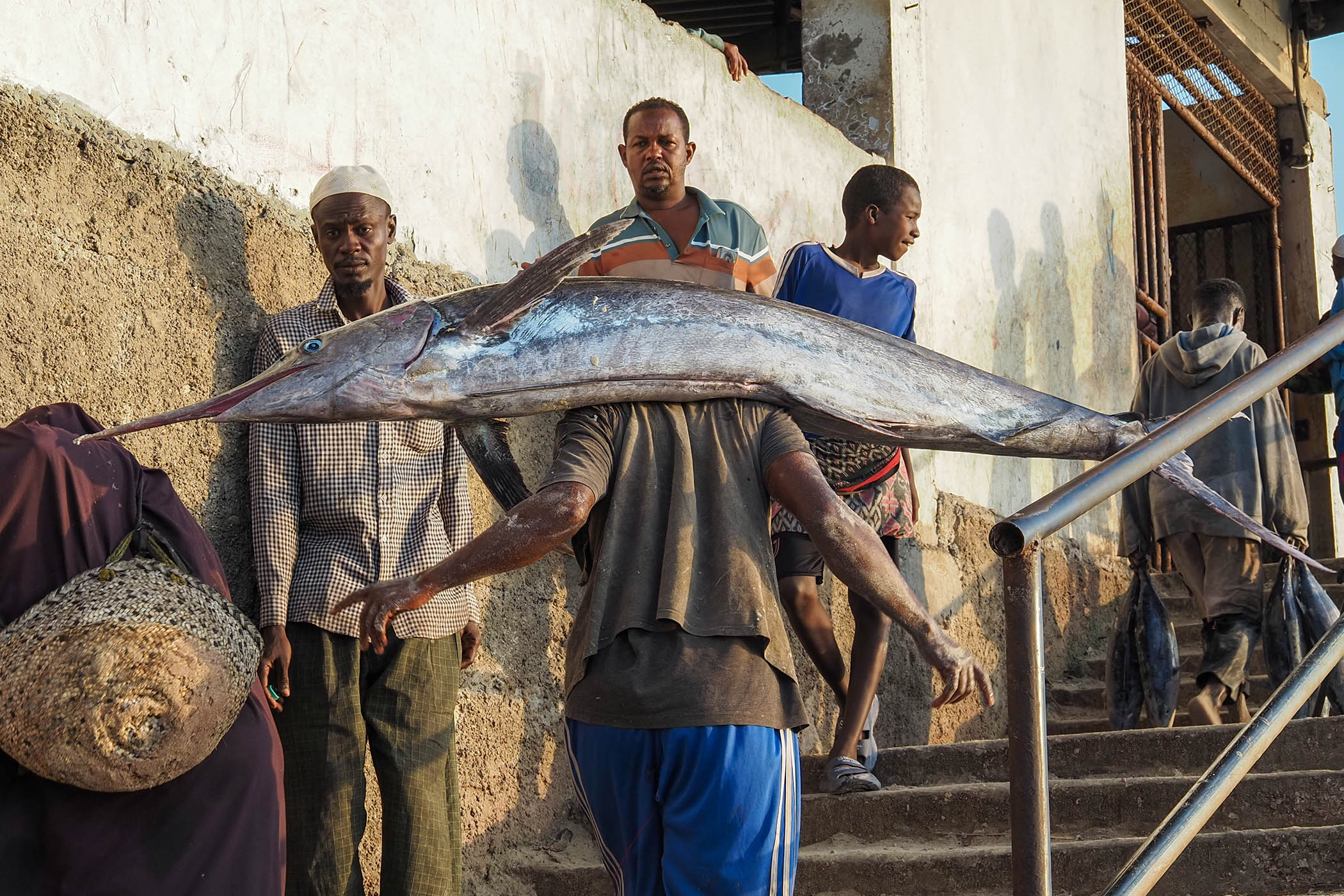 A man carries a catch into one of Mogadishu’s main fish markets