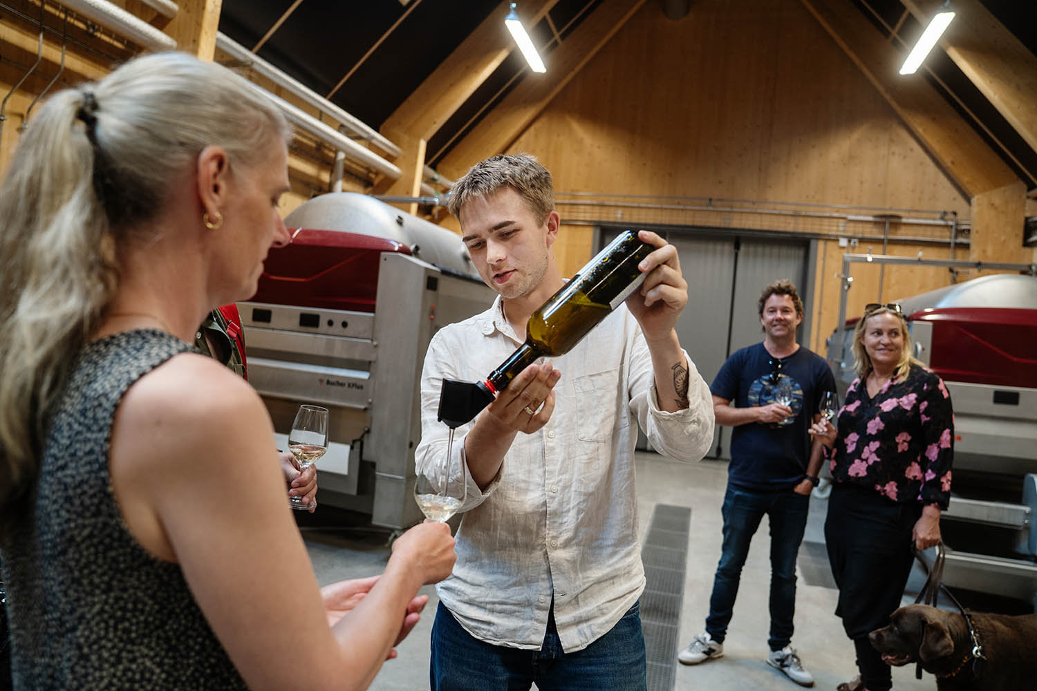 Wine educator Måns Wiberg pours a glass of white wine during the tour, which he begins by addressing the risks of alcohol.