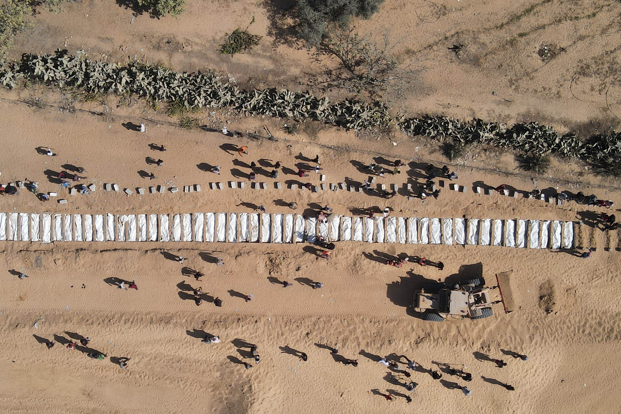 Some of the 285 bodies handed to the Palestinians in exchange for the bodies of Israeli hostages await burial in Gaza.
