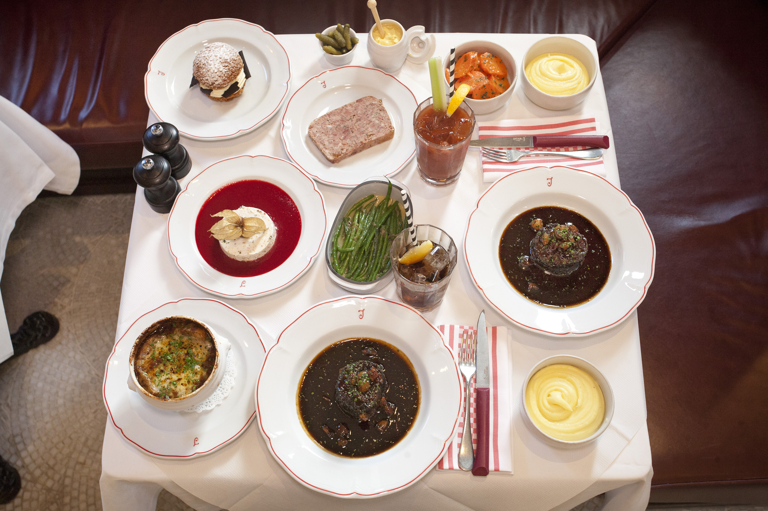 Tom ate terrine de campagne, £17.50, beef bourgignon, £16.50, nougat glace, £9. Alex ate soupe a l’oignon, £13.50, beef bourgignon, £16.50, choux a la creme chantilly, £9. They shared haricots vert a la Lyonnaise, £7, carrots vichy, £7, puree de pomme de terre, £7. Tom drank a virgin bloody mary, £8, and an americano, £3.50; Alex drank Coca Cola, £3
